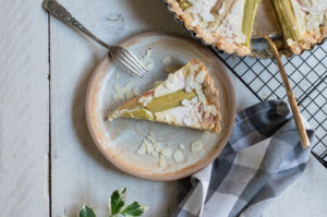 Stück Rhabarber Tarte glutenfrei mit Mandelsplittern und Puderzucker